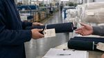 Textile material handoff in a factory representing supply-chain data readiness and product information flow