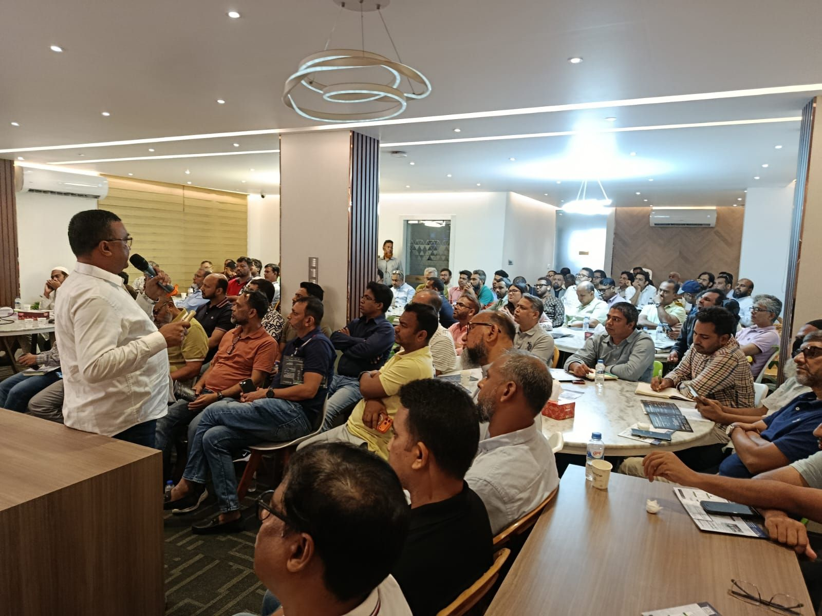 The lead trainer addresses participants during the BGBA × DeviceStamp DPP Awareness & Training Program in Dhaka.